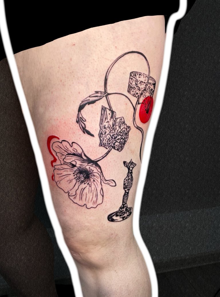 Poppy in a broken glass, thigh tattoo, side view