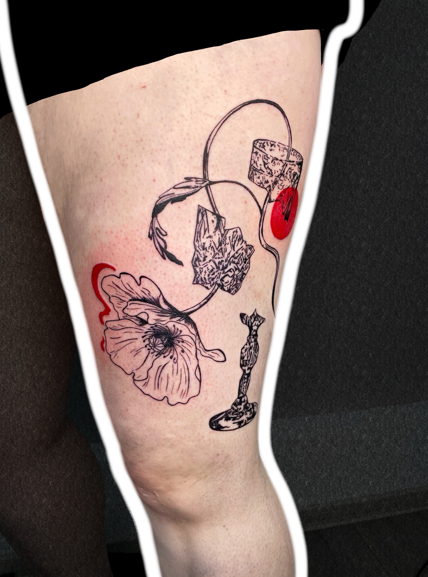 Poppy in a broken glass, thigh tattoo, side view