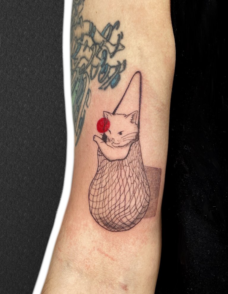 Cat in a net bag, arm tattoo