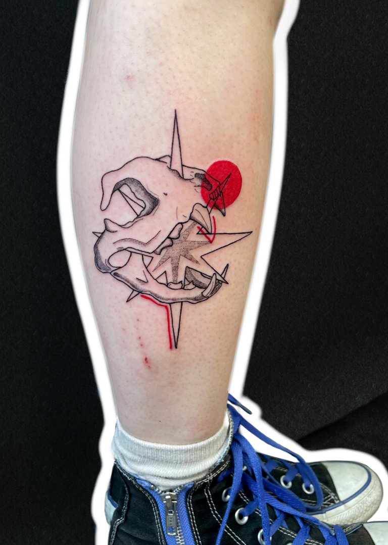 Skull with a compass star, calf tattoo