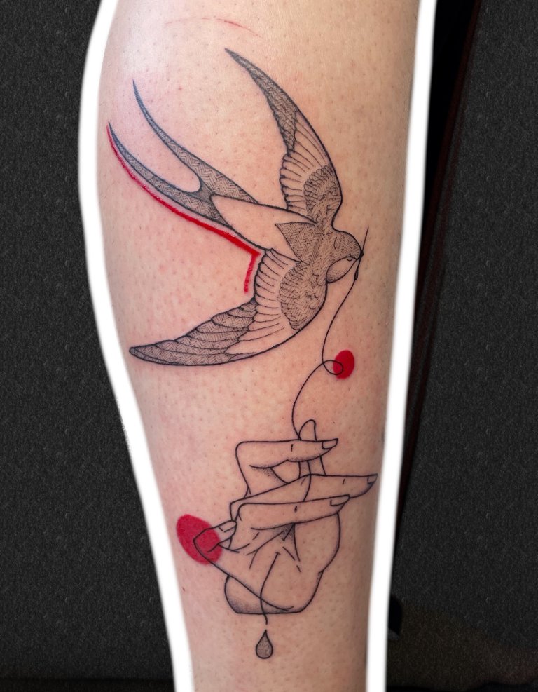 Swallow and a hand, forearm tattoo